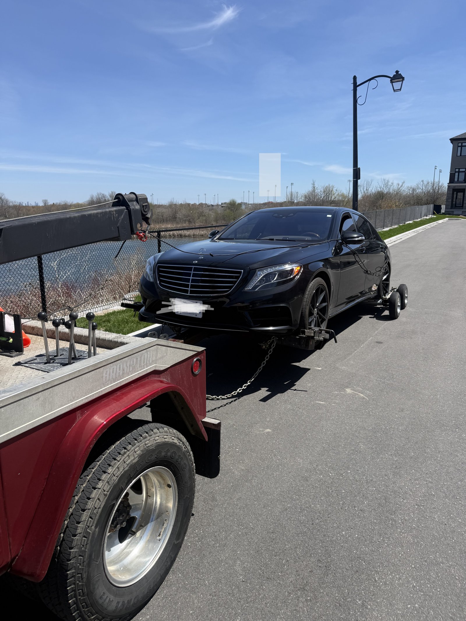 Tow truck with black Mercedes-Benz being towed in Brampton GTA